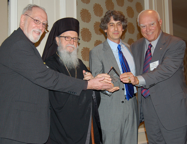 Archbishop Demetrios and Charles H. Cotros, Chairman of L100, joined by Fr. Eugene Pappas, far left, present Archbishop Iakovos Leadership 100 Award for Excellence to Alexander Payne, second from right, Photo: ETA PRESS