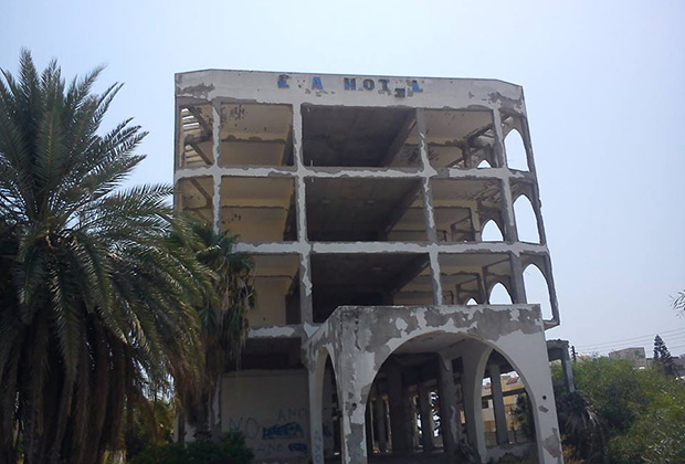 An abandoned and decaying hotel sits on the waterfront in Larnaca, Cyprus