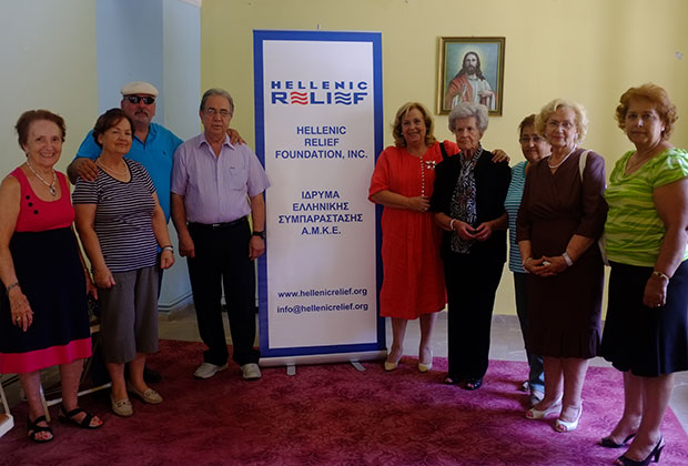 Hellenic Relief Board of Directors members Tassos Philippakos and Stelios Taketzis with head volunteer Maria Siourdi and ladies of the Christian Association of Women in Gytheio