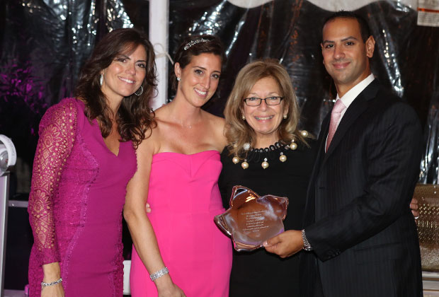 Despina Yarian, Founder and Co Chair, Katerina Dinas Raptis, President, and George Raptis, Founder and Co Chair, presenting Dr. Maria Theodoulou of MSKCC with a silver plaque