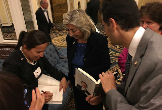 Congresswoman Dina Titus and Congressman John Sarbanes getting their copies signed, at the AHEPA Congressional Banquet in Washington