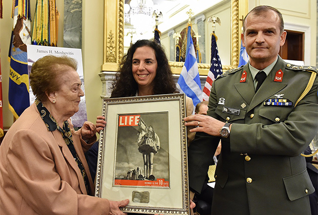 Themis Douratsou-Paleologou and Sophia Paleologou accept the 2015 Greatest Generation Award on behalf of General George Douratsos from Greek Defense Attaché Panagiotis Kavidopoulos, PHOTO BY: BILL PETROS