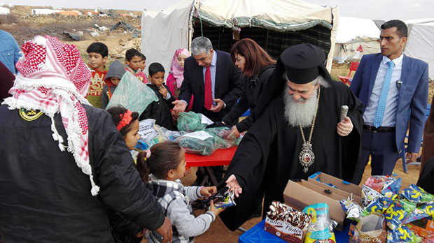 Patriarch Theophilos III visiting the camps and offering gifts
