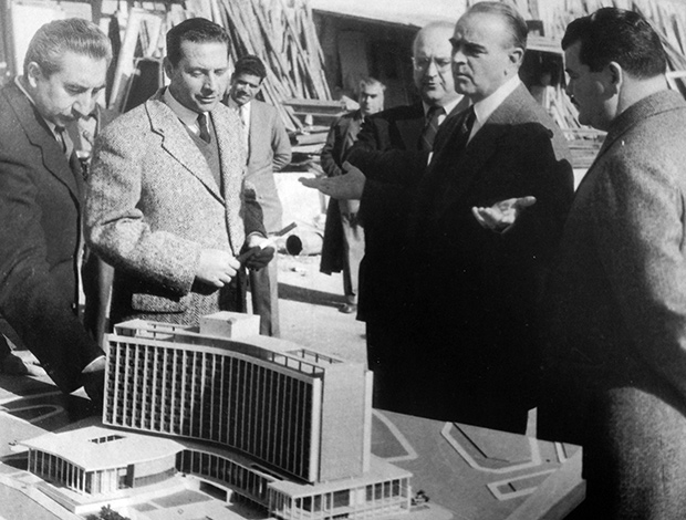 Architect Spyros Staikos is presenting the hotel's building plans to then Prime Minister Konstantinos Karamanlis with future President of the Republic Konstantinos Tsatsos and Minister Emmanuel Kephalogiannis