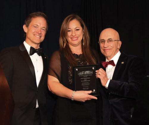 Mike Manatos and Menas Kafatos award the Aristeion Award to Kelly Vlahakis-Hanks