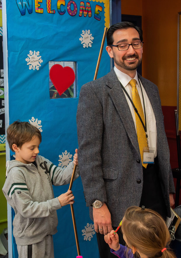 Mr. George is measured by a second grader using meter sticks. Photo: Sotiris Michalatos/TCS