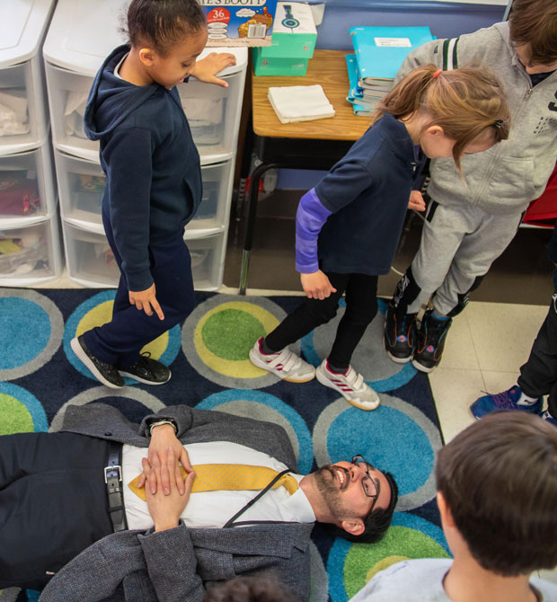 Mr. George is measured by a second grader who paces the perimeter around him. Photo: Sotiris Michalatos/TCS