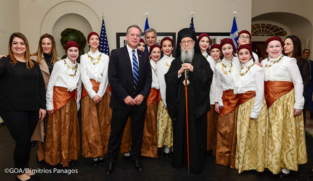 Students wearing traditional costumes, their teachers, Archbishop Demetrios and George Koumoutsakos, New Democracy Shadow Foreign Minister