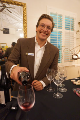 Peter Koros, part of the next generation of the Fotinos Family, pours wine at their 50th anniversary celebration.