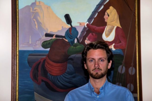 Pavlos Demertzis-Bouboulis in front of a painting of Laskarina Bouboulina in naval battle. Courtesy of Pavlos Demertzis-Bouboulis