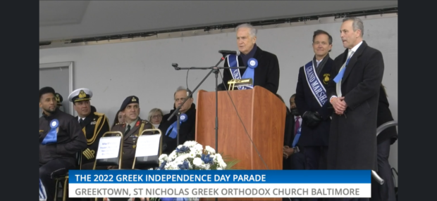 Andy Manatos at the podium with Mike Manatos and Maryland Greek Independence Day Parade Chairman Col. George Stakias