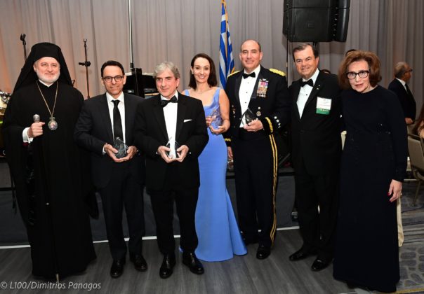 Archbishop Elpidophoros of America, (Left) and Demetrios G. Logothetis and Paulette Poulos (Far Right) present the Archbishop Iakovos Leadership 100 Award for Excellence to (L to R) to Dr. Theodoros Teknos, Dr. Leonidas Platanias, Matina Kolokotronis, and General Andrew P. Poppas, at Leadership 100 Grand Banquet; PHOTO: DIMITRIOS PANAGOS