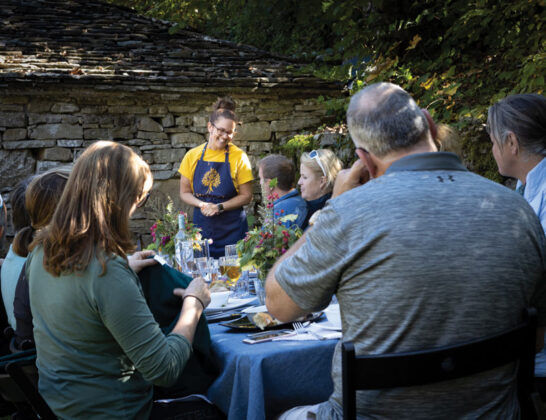 Anna serving visitors during a mountain picnic she organized for foreign travelers