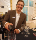 Peter Koros, part of the next generation of the Fotinos Family, pours wine at their 50th anniversary celebration.