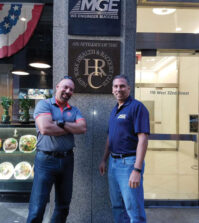 Michael and Peter standing in front of the MG Engineering headquarters on 32nd Street